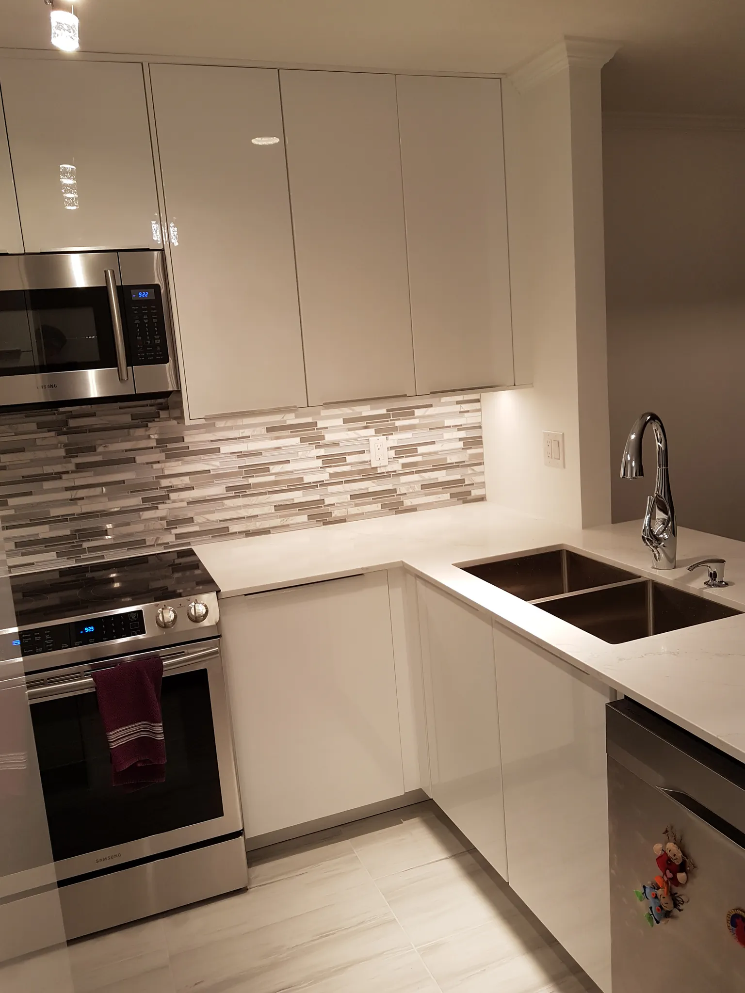 Kitchen renovation process North Vancouver - modern white cabinets mosaic backsplash finished result