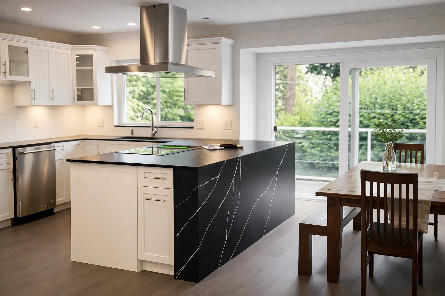 kitchen renovation cost north vancouver - open concept black island white cabinets by Arani Construction